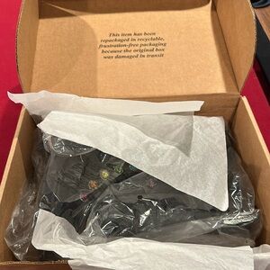 Combat-style boot that has a zipper and sparkly rainbow jewels.